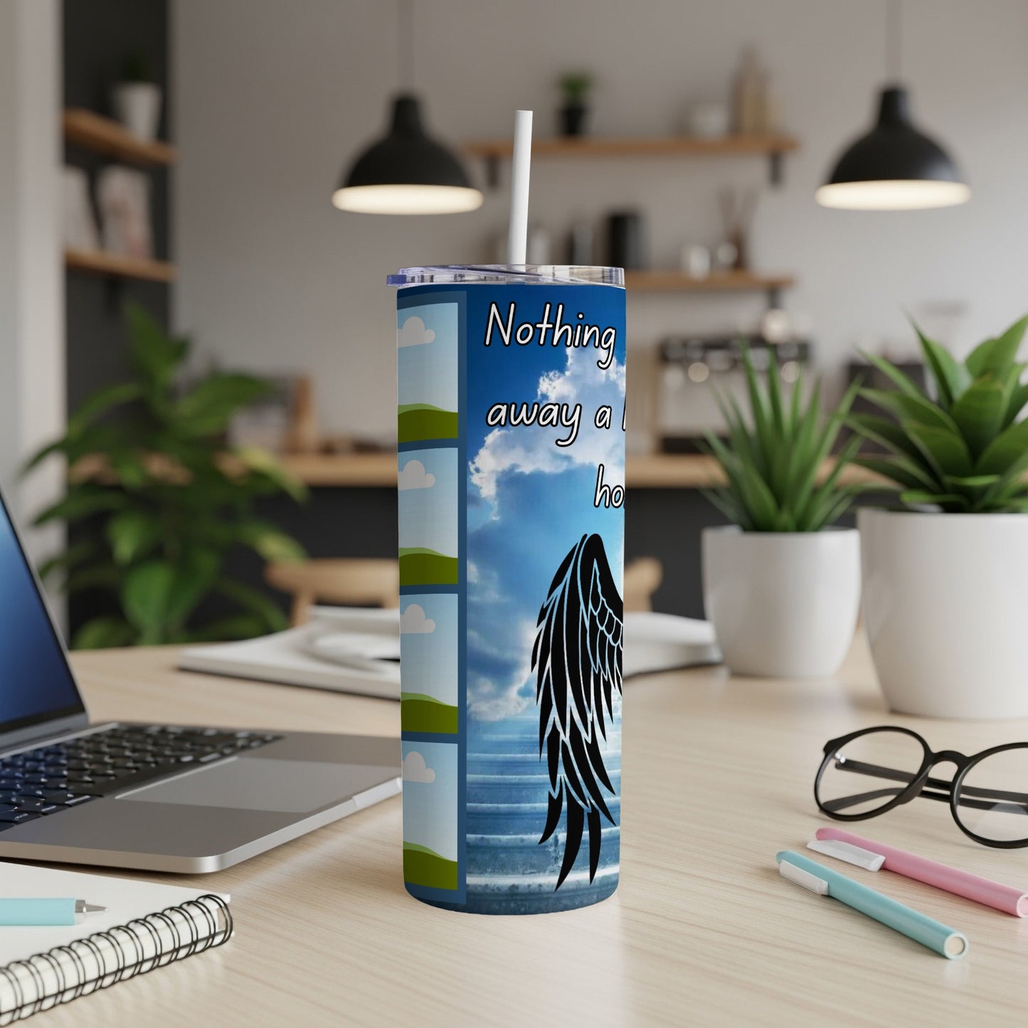 Tumbler with text "Nothing away a ho" and black angel wings on a sky background.