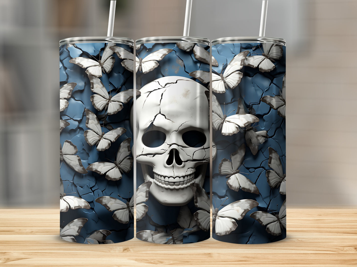 Three tumblers with a cracked skull and white butterflies on a blue textured background.