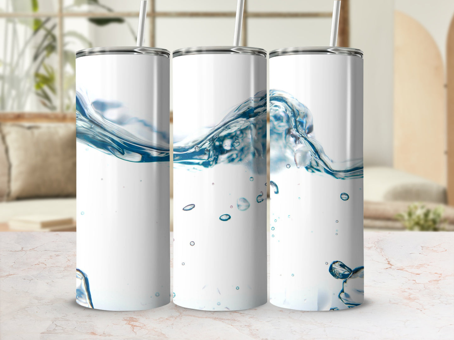 Three white tumblers with a water splash design and straws.