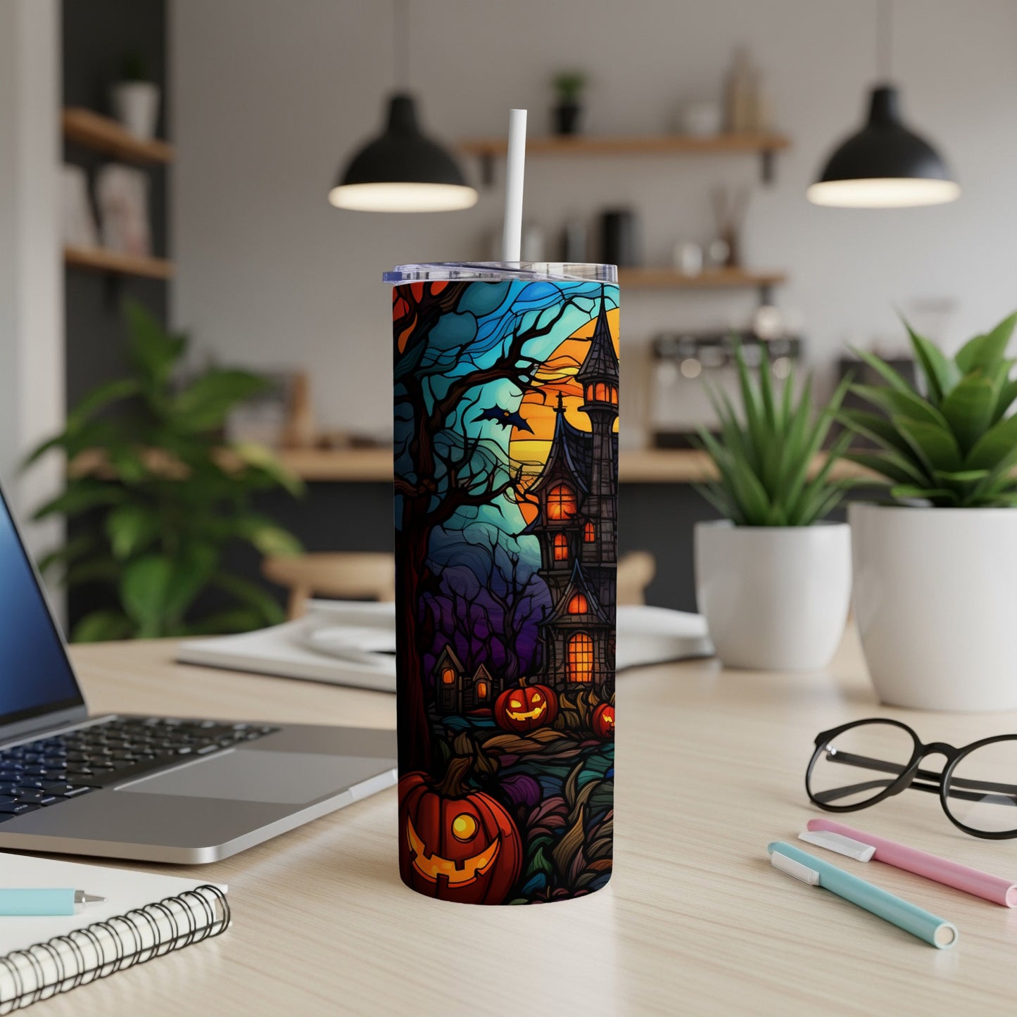 Halloween tumbler with haunted house, pumpkins, and spooky trees.