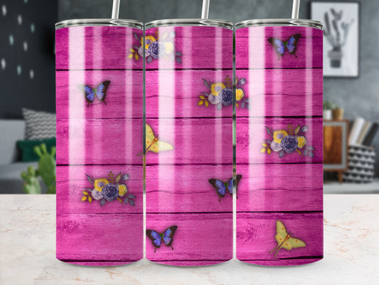 Pink wooden tumbler with scattered butterflies and floral designs.