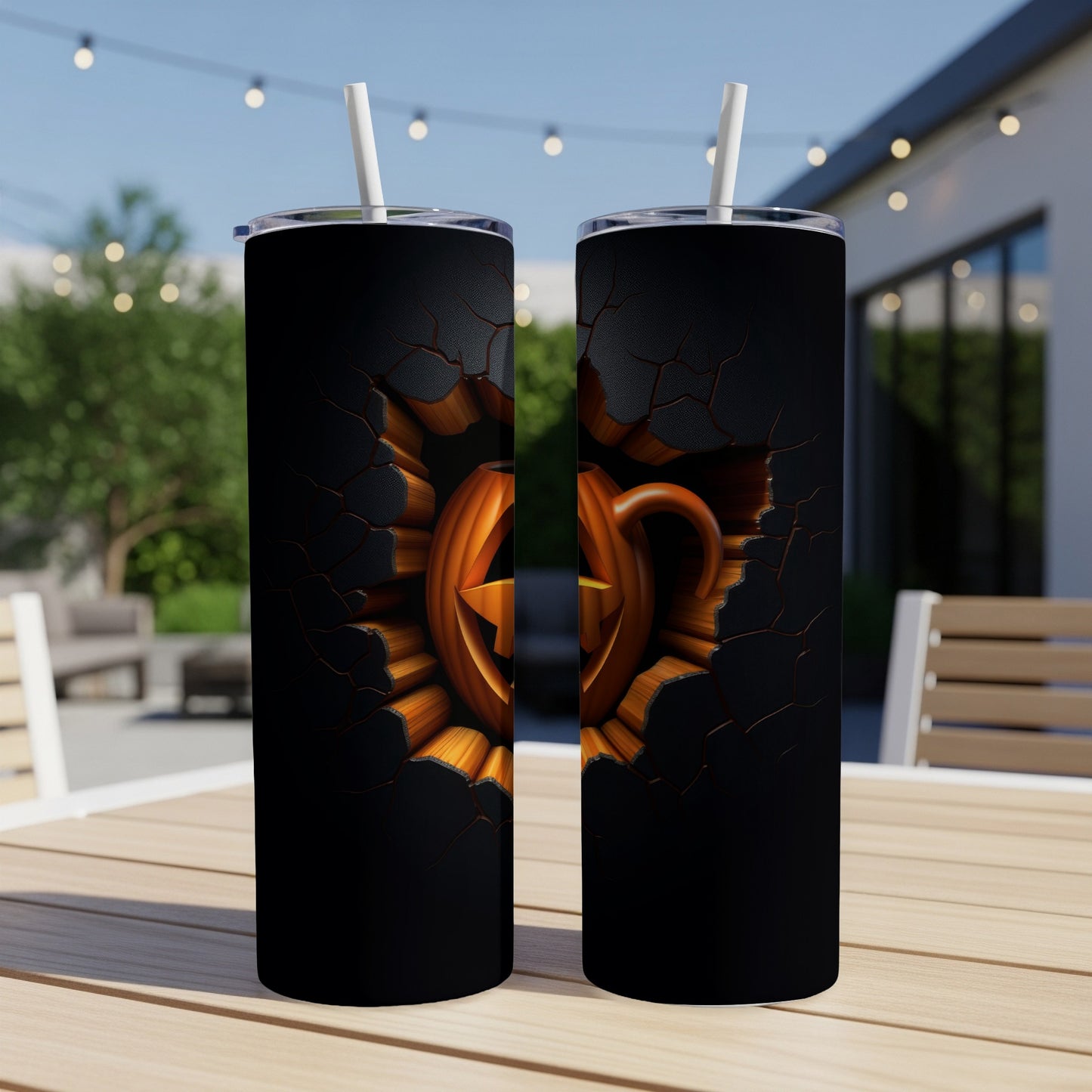 Two tumblers with a cracked black surface revealing a carved jack-o'-lantern.
