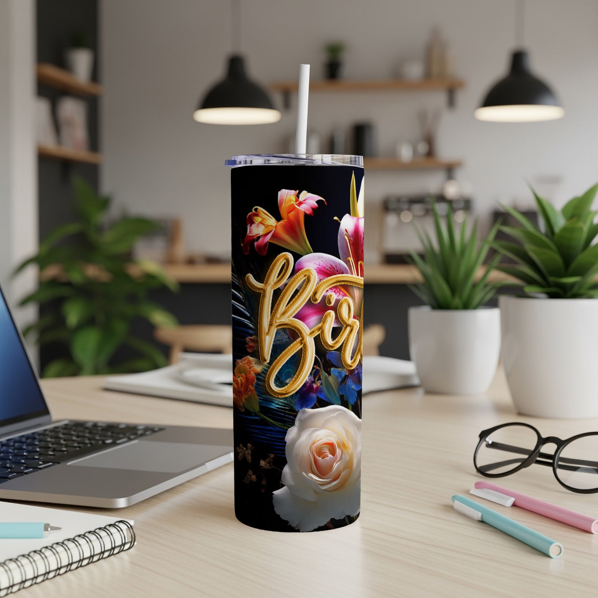 Black tumbler with floral design and "Bae" text, on a desk.
