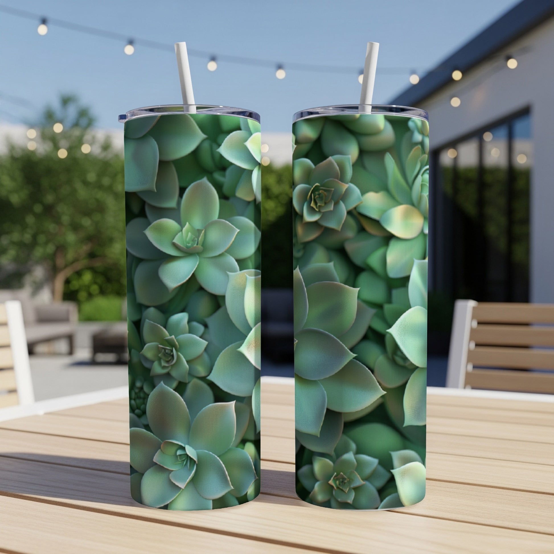 Two green succulent tumblers with straws on a wooden table.