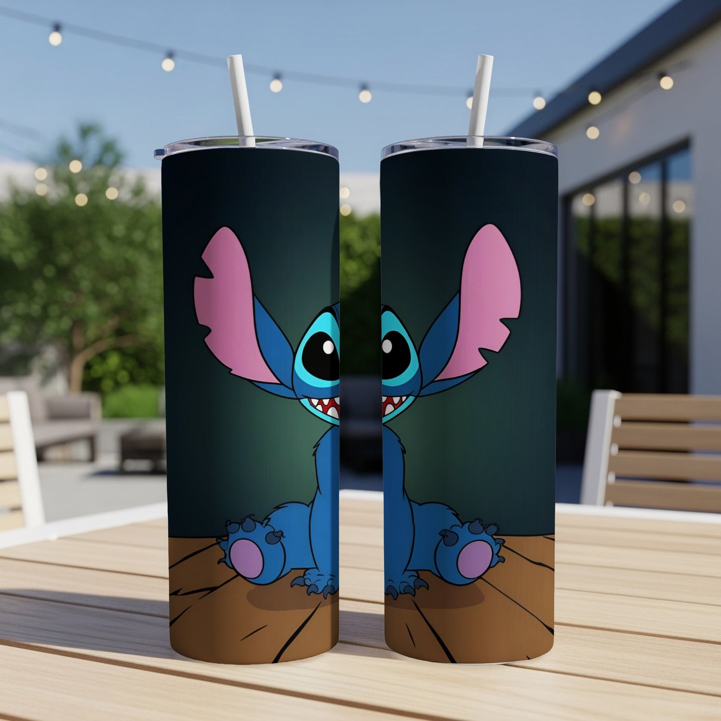 Two blue Stitch tumblers with straws on a wooden table.