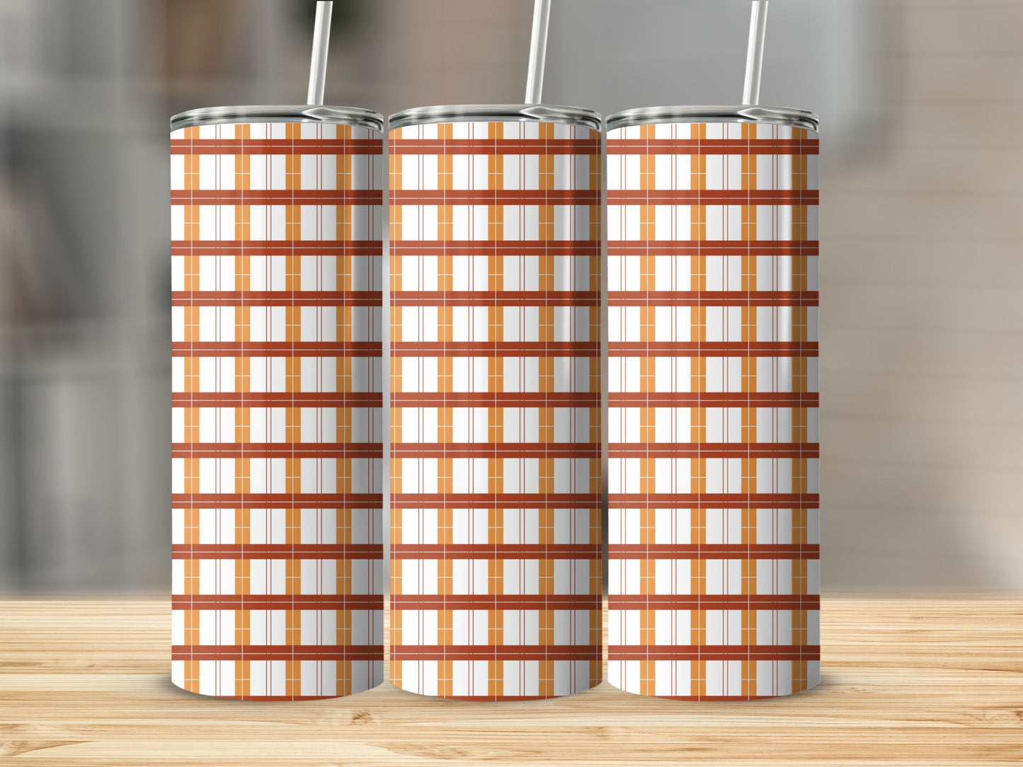 Three tumblers with a plaid pattern of orange and white lines.