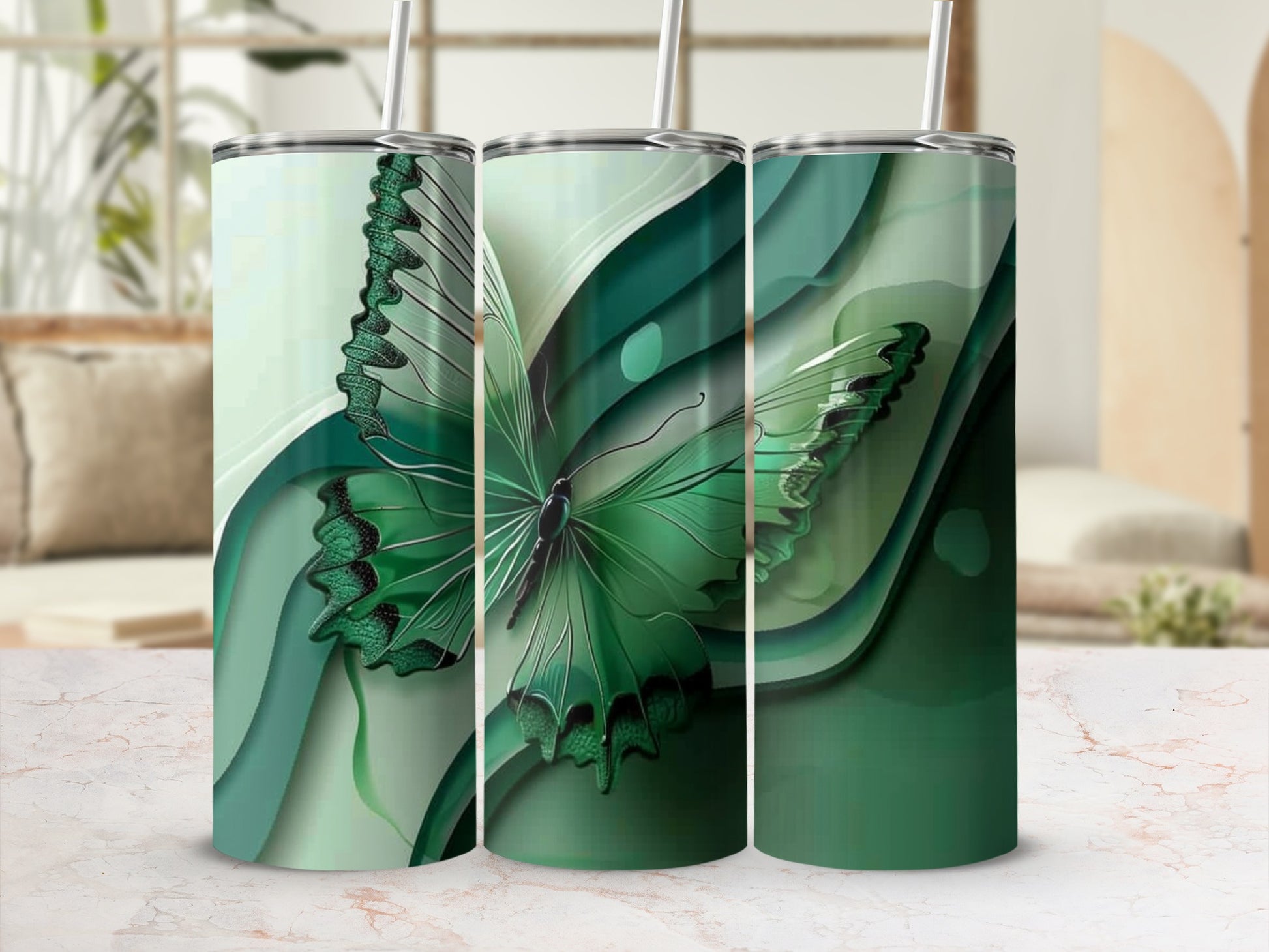 Green butterfly with layered green abstract design on three tumblers.