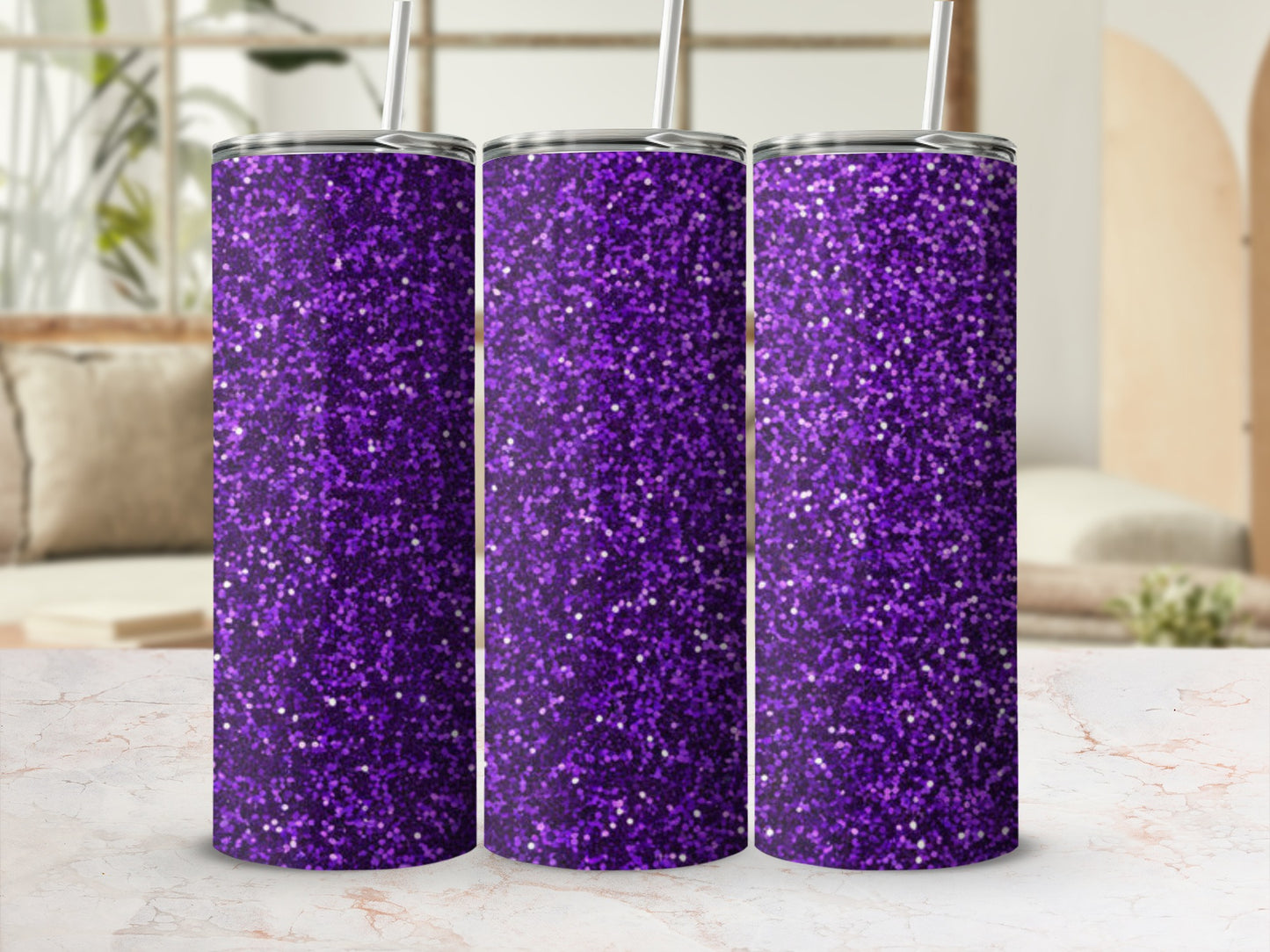 Three tall purple glitter tumblers with straws stand on a marble surface.