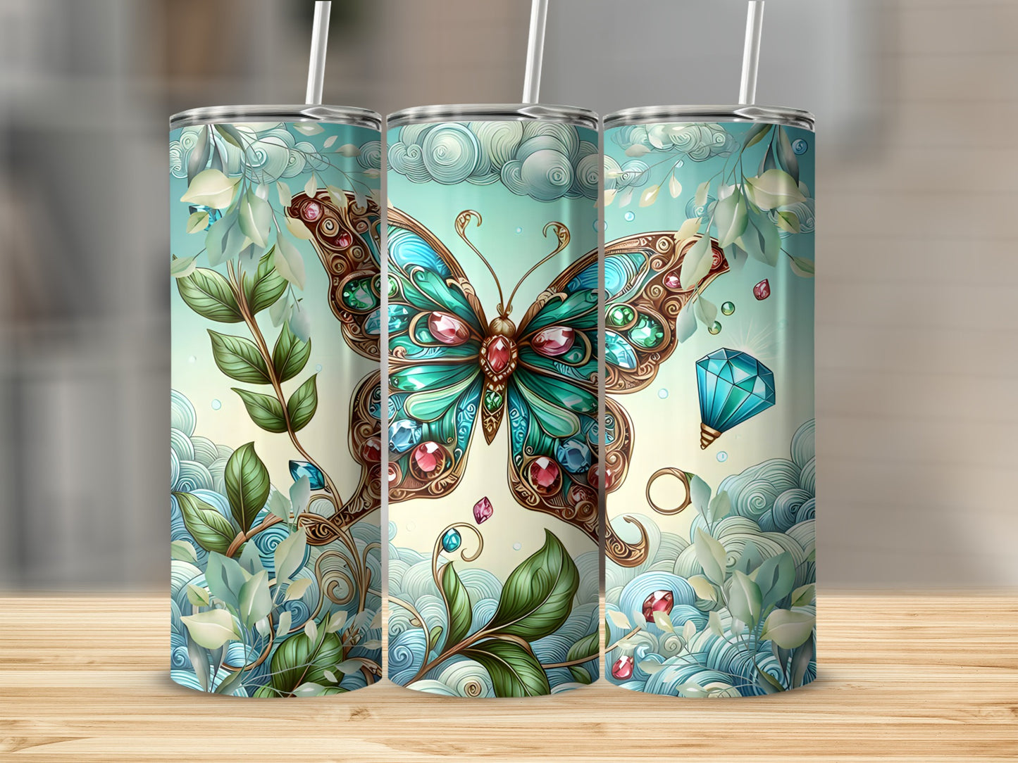 Three tumblers featuring a jeweled butterfly and swirling floral designs.