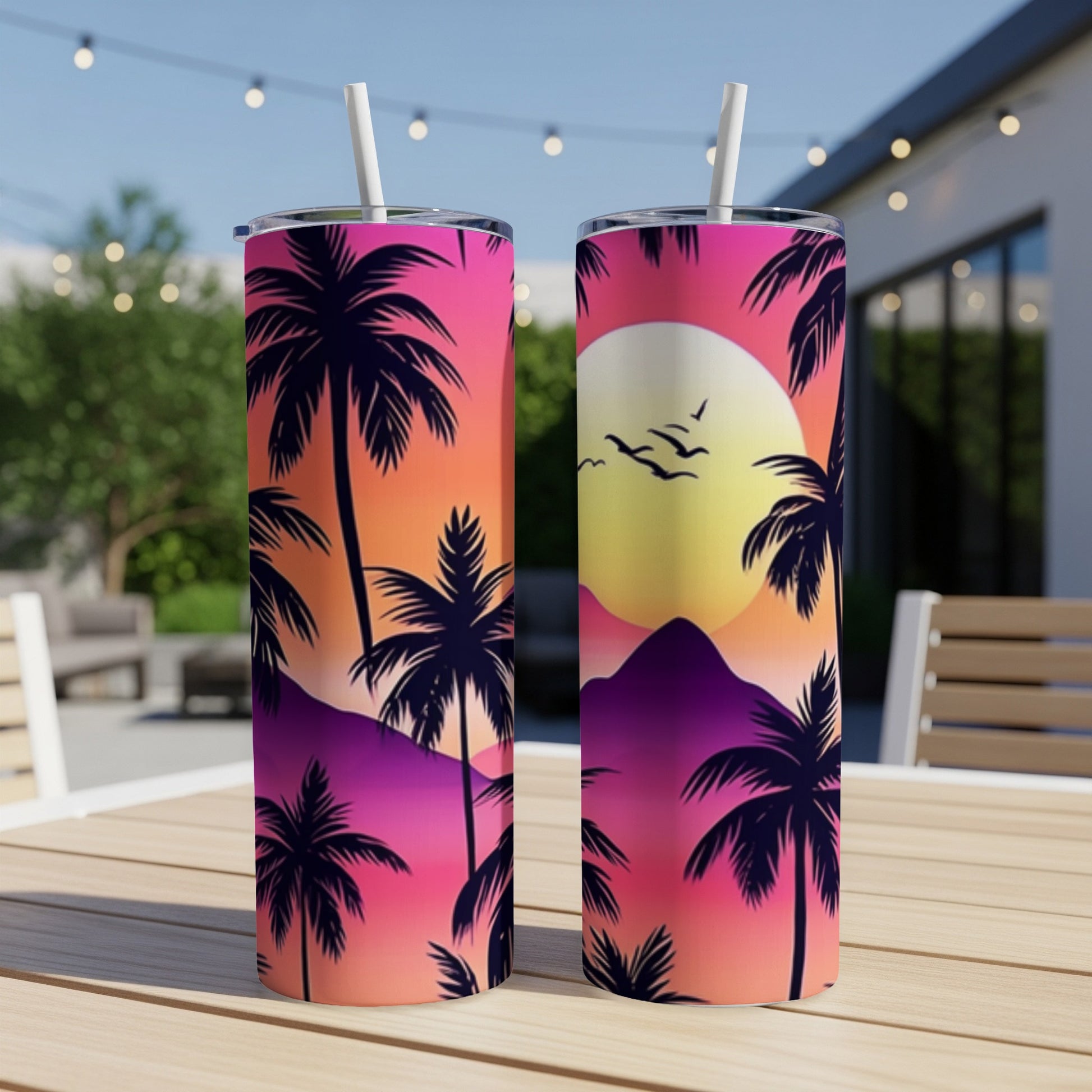 Two tumblers with a vibrant sunset beach scene, palm trees, and mountains.