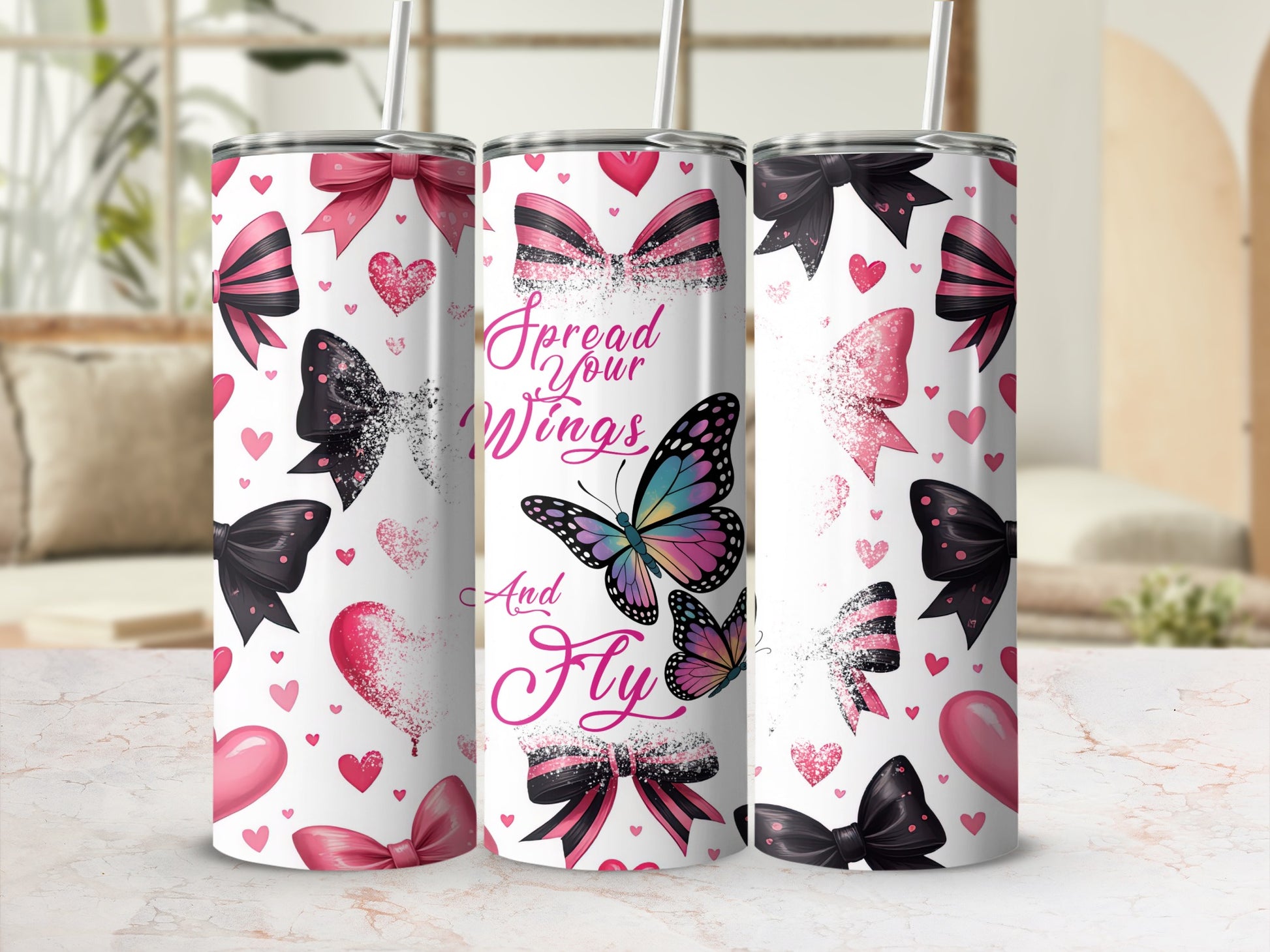 White tumbler with pink and black bows, butterflies, and hearts, text "Spread Your Wings And Fly".