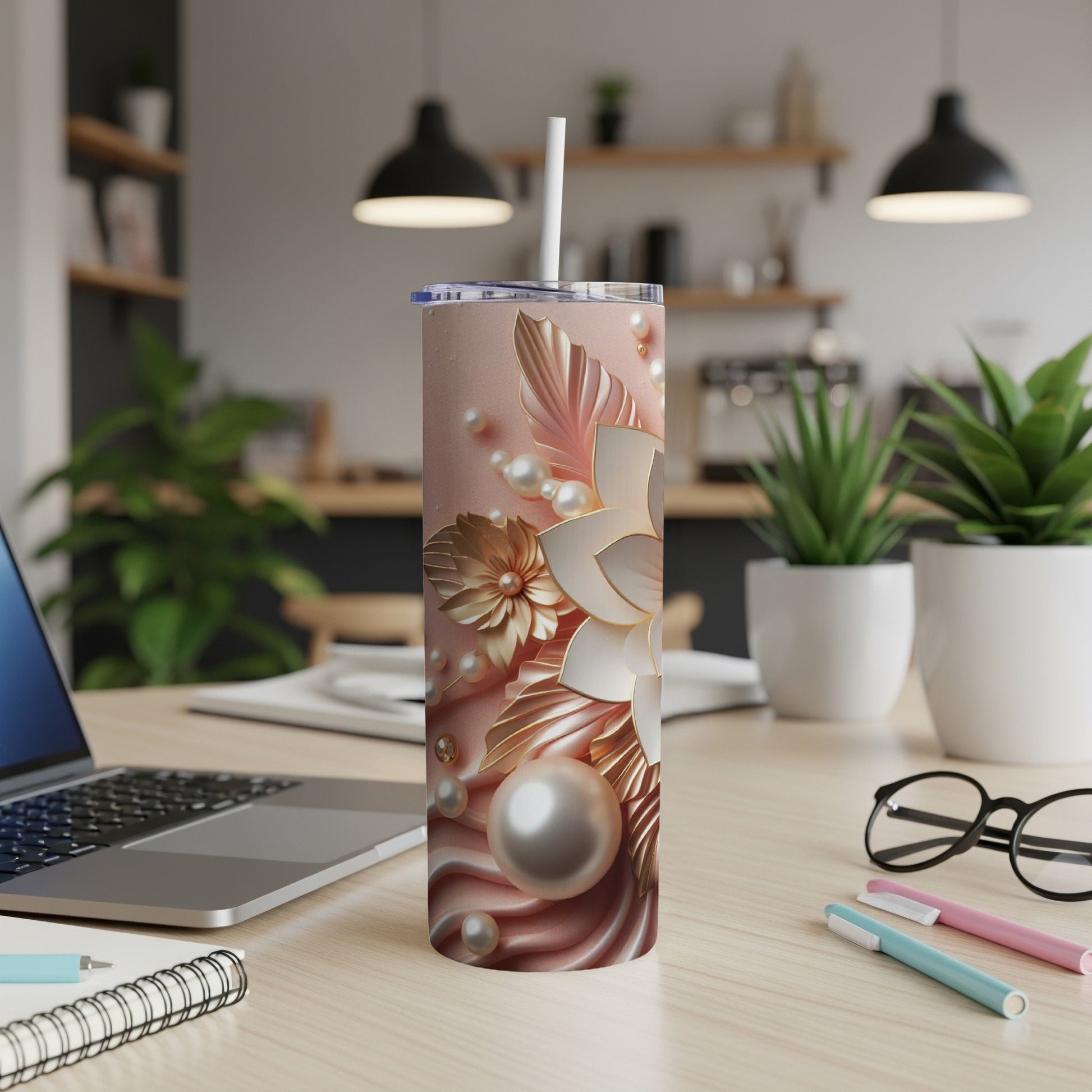 Rose gold tumbler with floral and pearl accents.