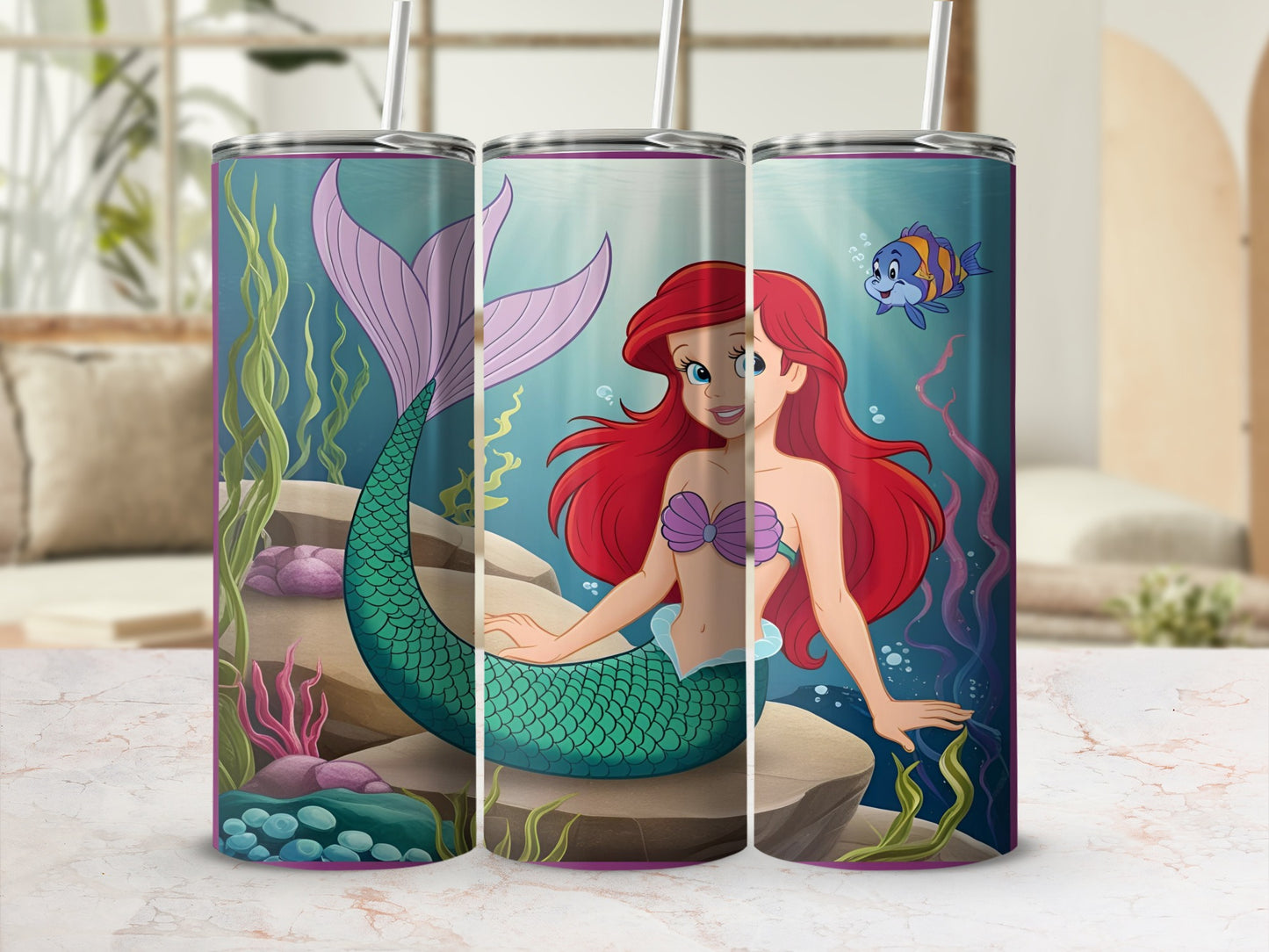 Ariel the mermaid sits on a rock with a fish swimming nearby.