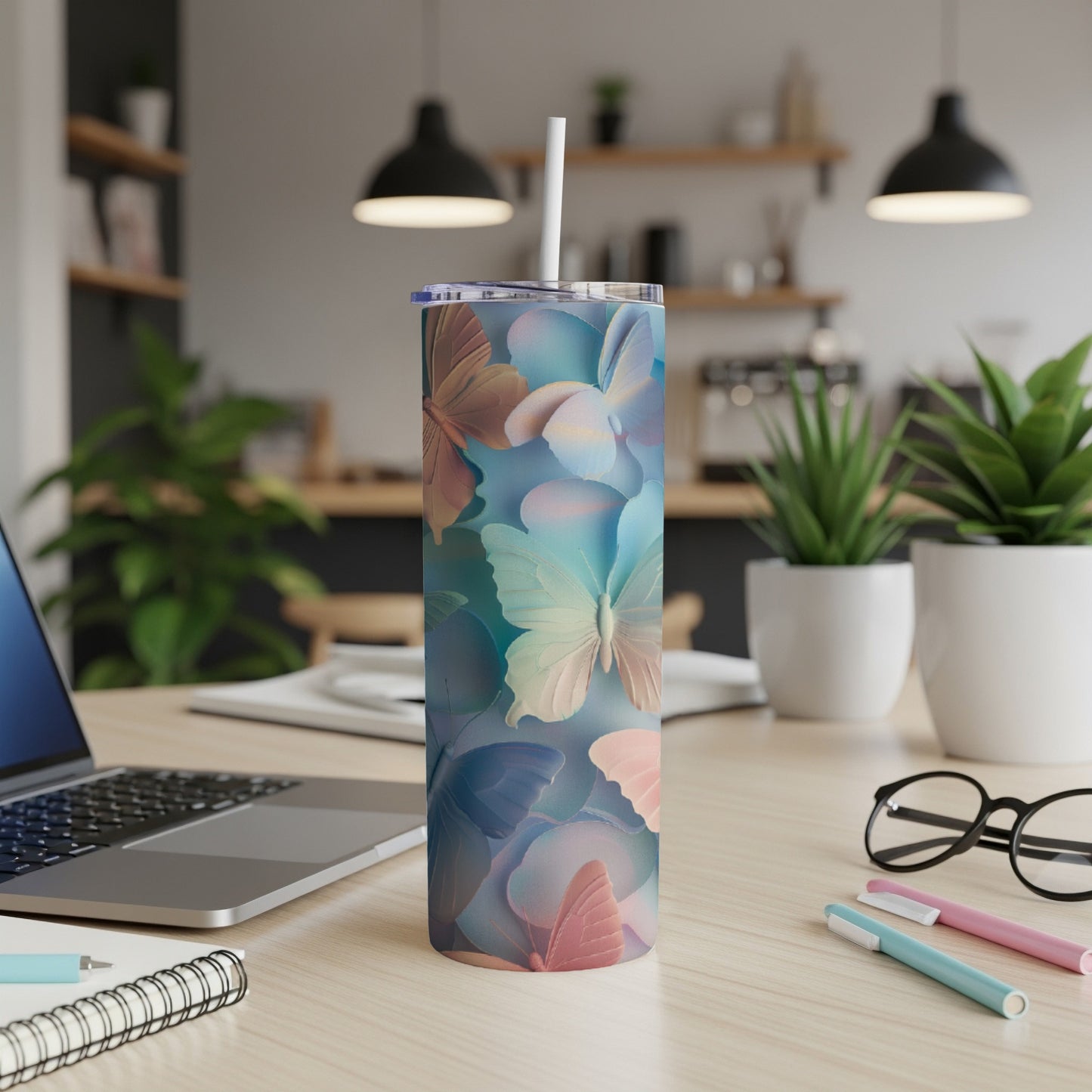 Multicolor butterfly pattern on a tall, skinny tumbler with a straw.