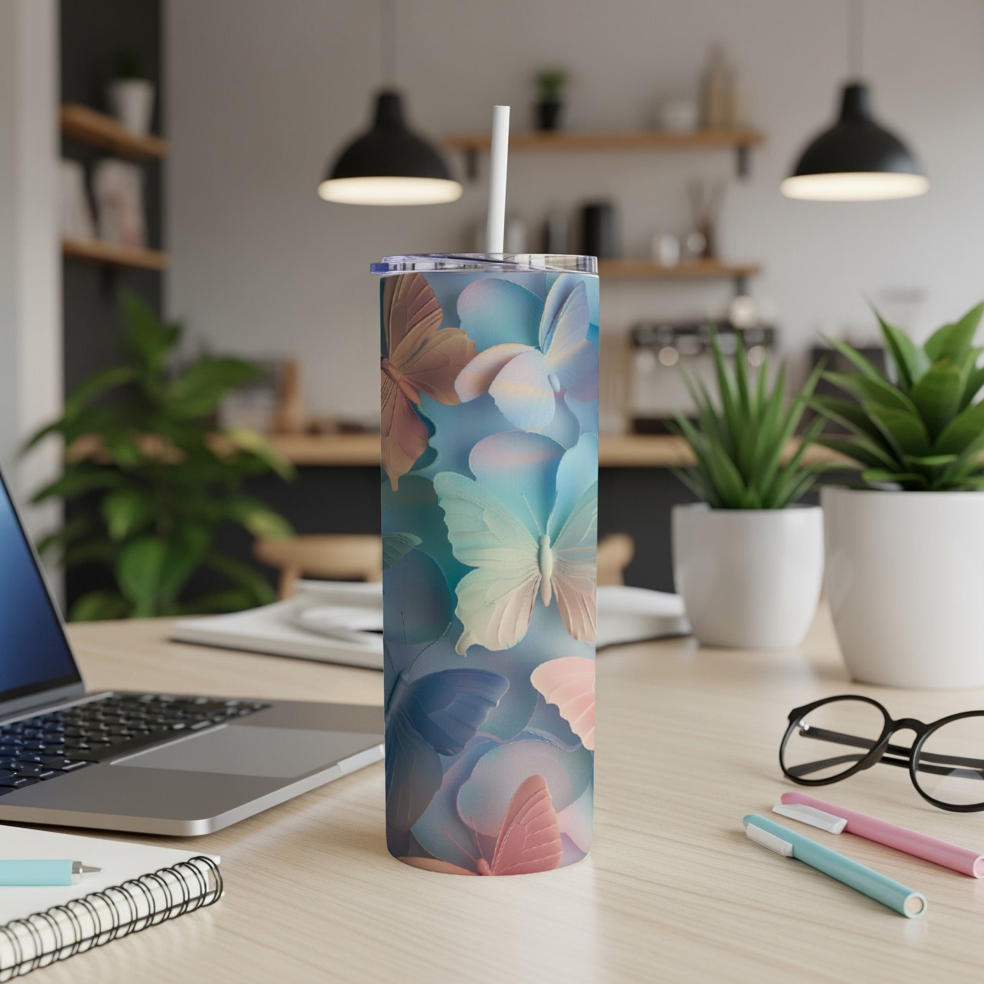 Multicolor butterfly pattern on a tall, skinny tumbler with a straw.