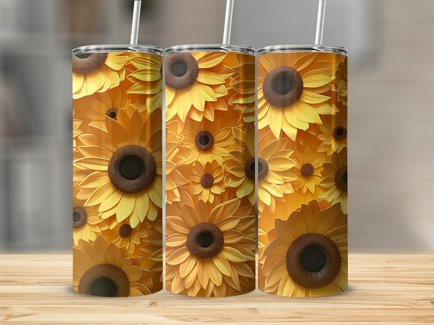 Three tumblers with a vibrant sunflower pattern on a wooden surface.