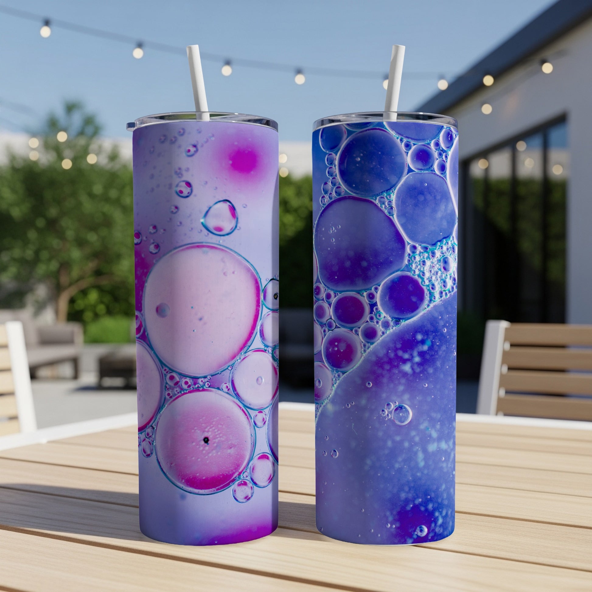 Two tall tumblers with marbled purple and blue bubble patterns.
