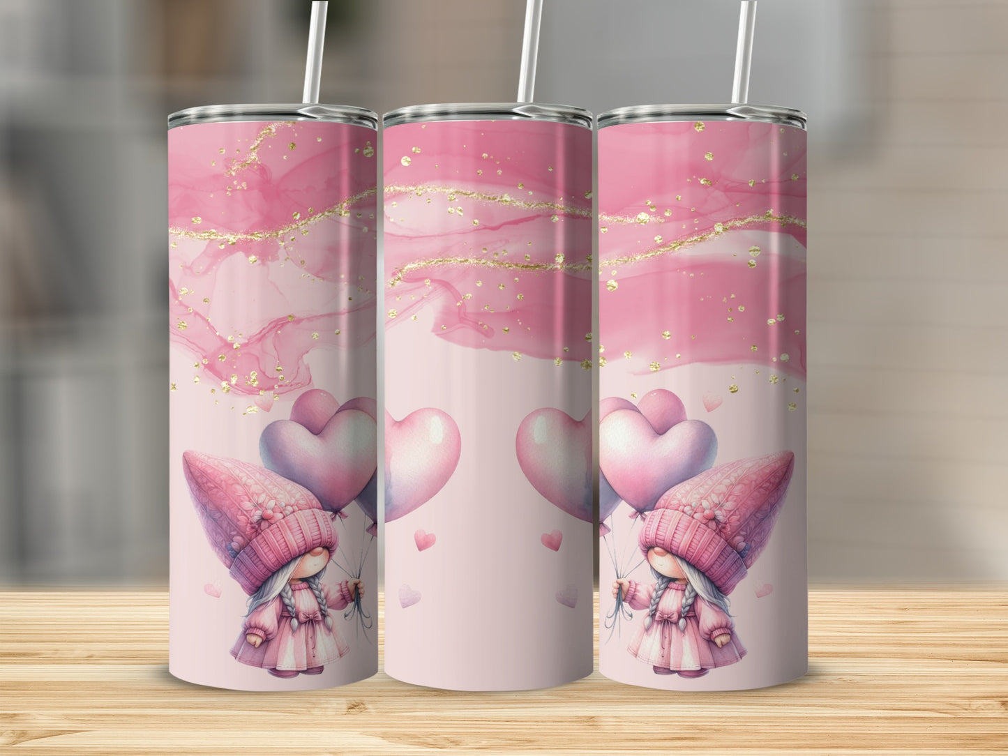 Three pink tumblers with gnomes holding heart balloons and gold glitter accents.