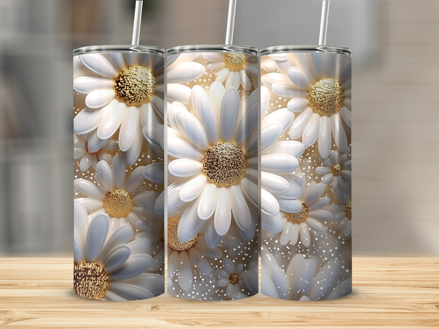 Three tumblers with white daisy floral design and gold accents on wooden surface.