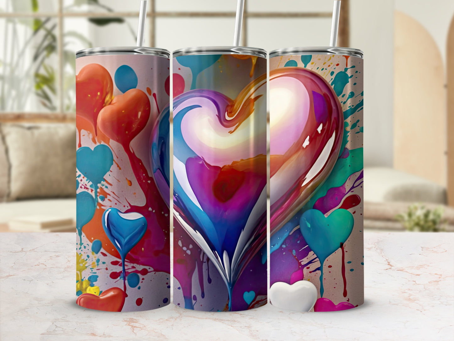 Tall tumbler with colorful heart design and paint splatter.