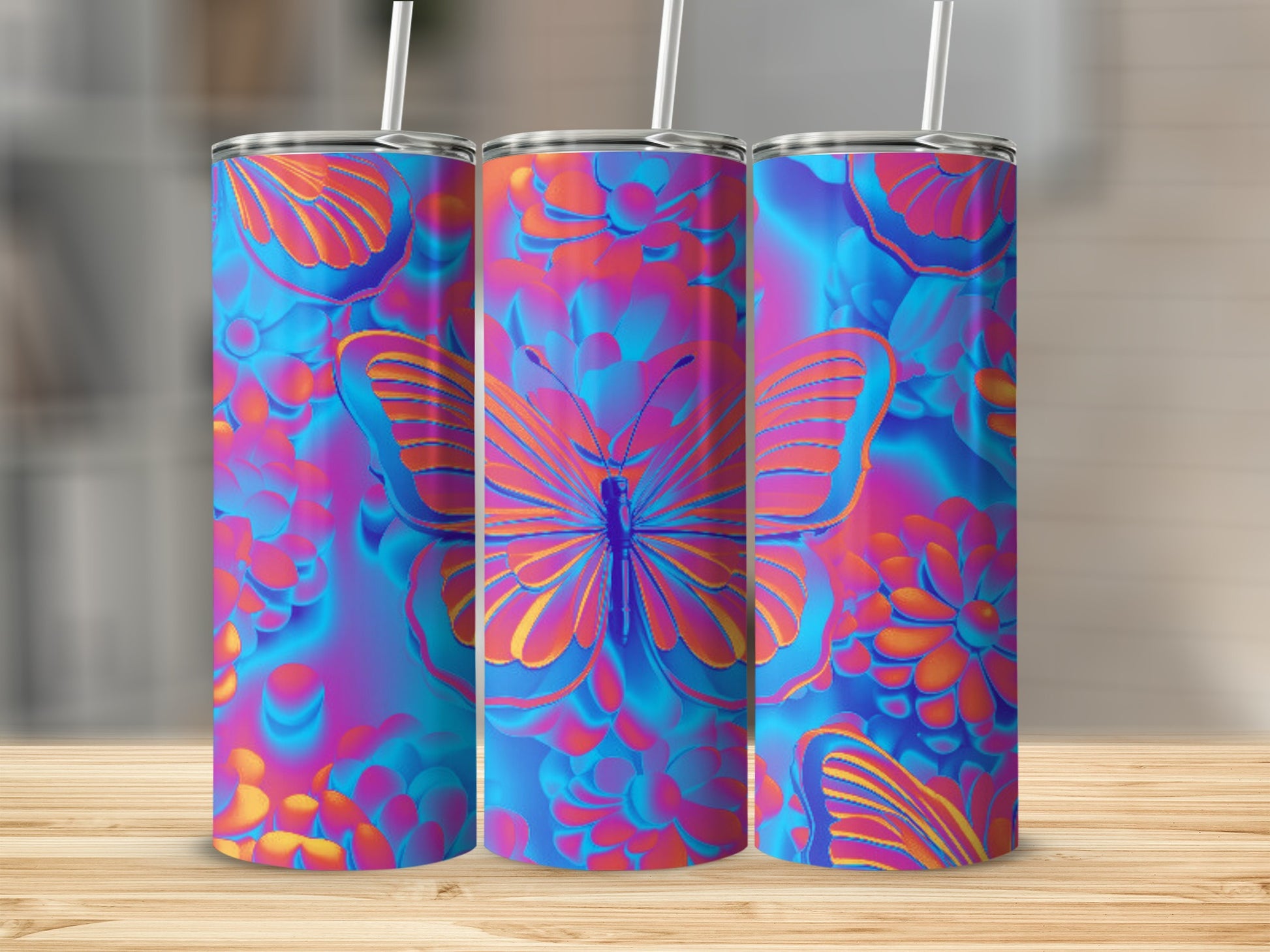 Three tumblers with neon butterfly and floral designs on a wooden surface.