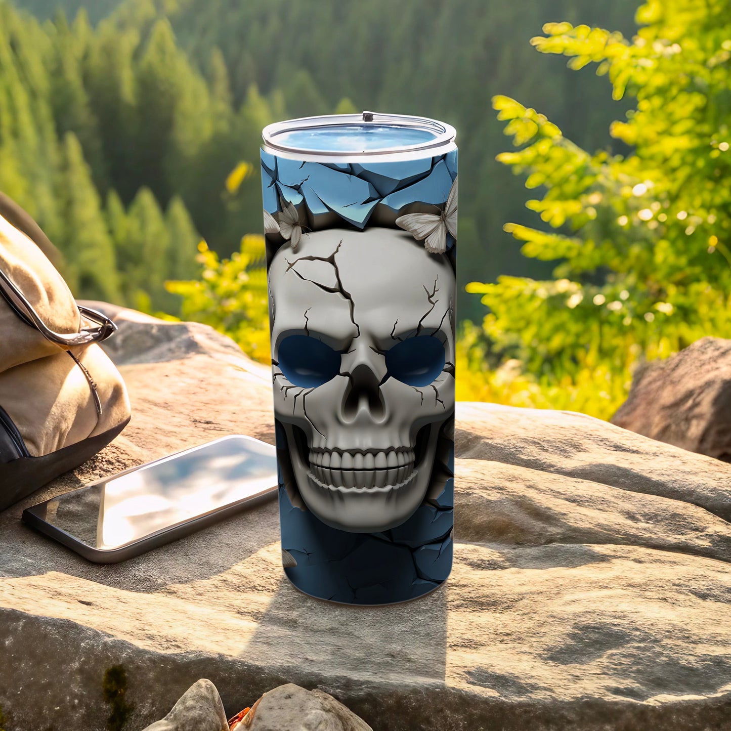 Blue tumbler with cracked skull and butterfly design.