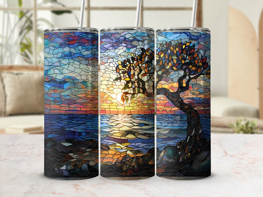 Stained glass tumbler with sunset tree design.