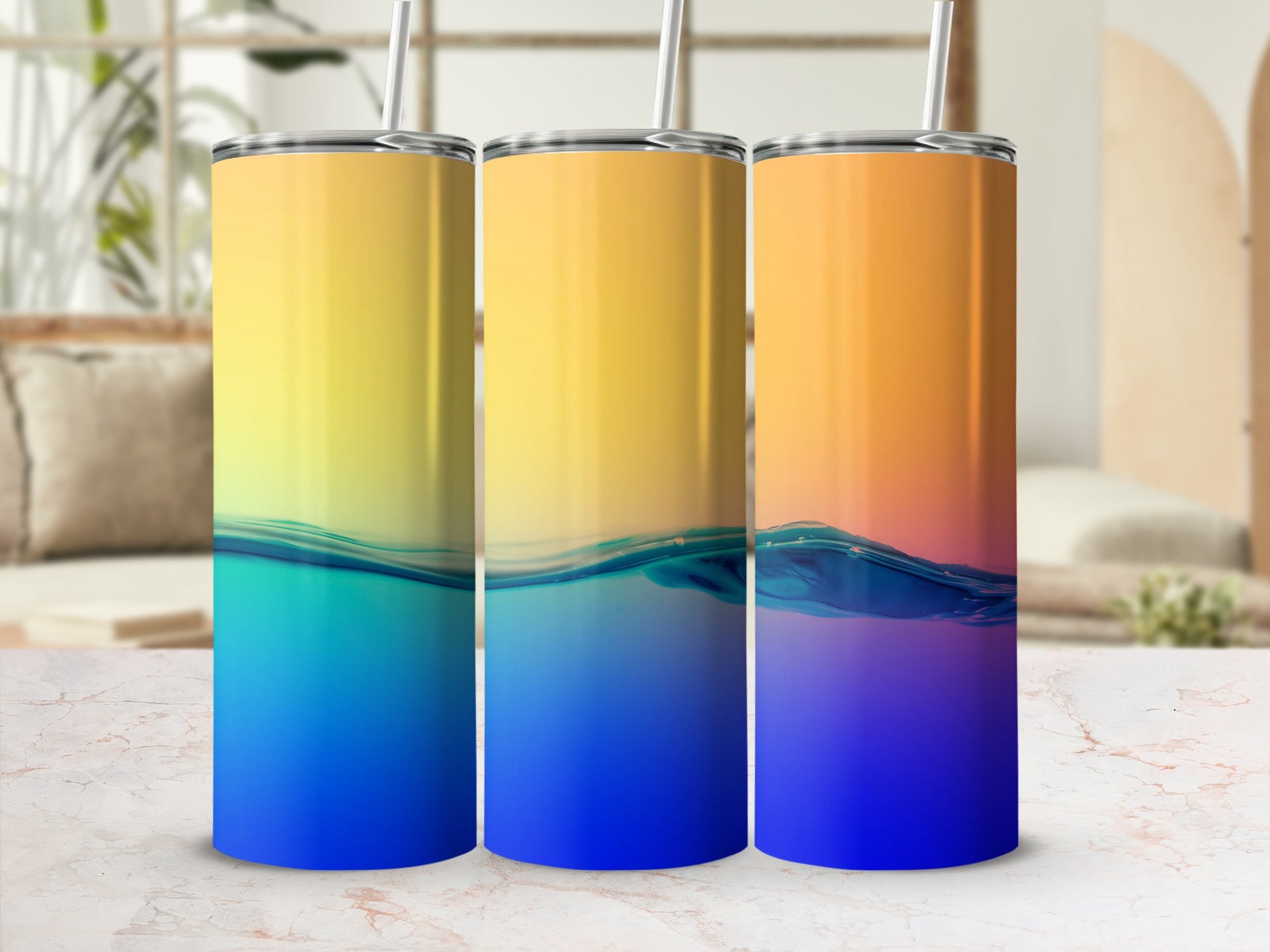 Three tumblers with a gradient of yellow, orange, and blue water.