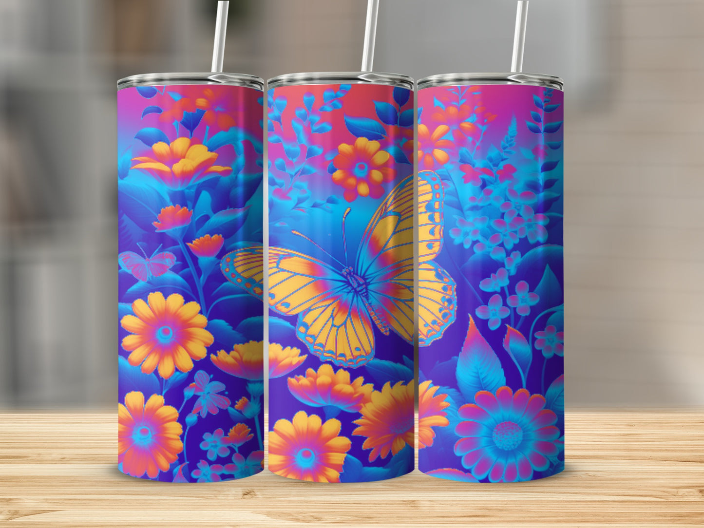 Floral butterfly design on three colorful tumblers with straws.
