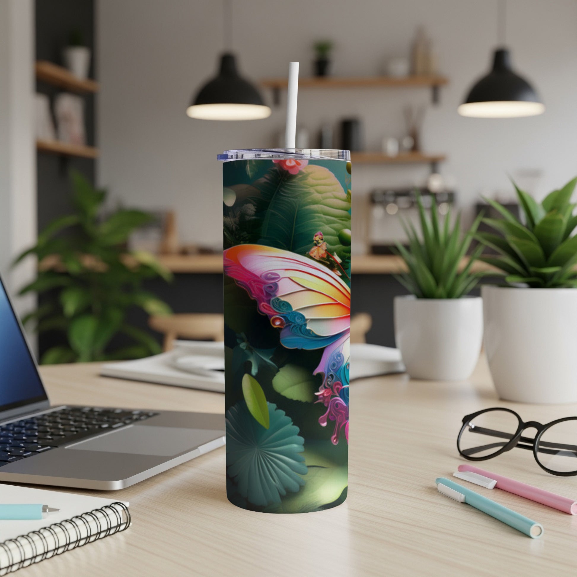 Butterfly design on a white tumbler with a straw, on a wooden desk.