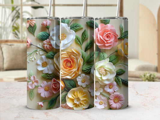 Three floral tumblers with rose and daisy designs on a marble surface.