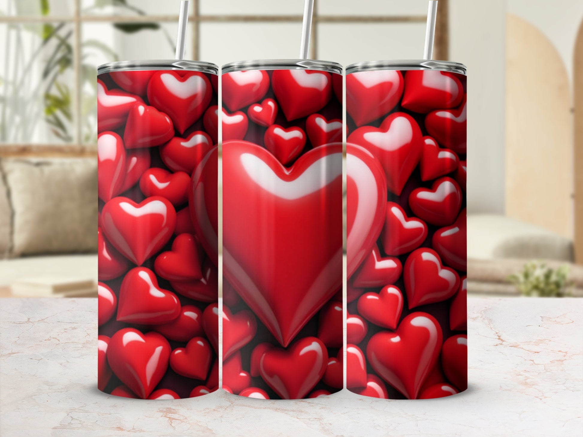 Three tumblers covered in red hearts with straws.