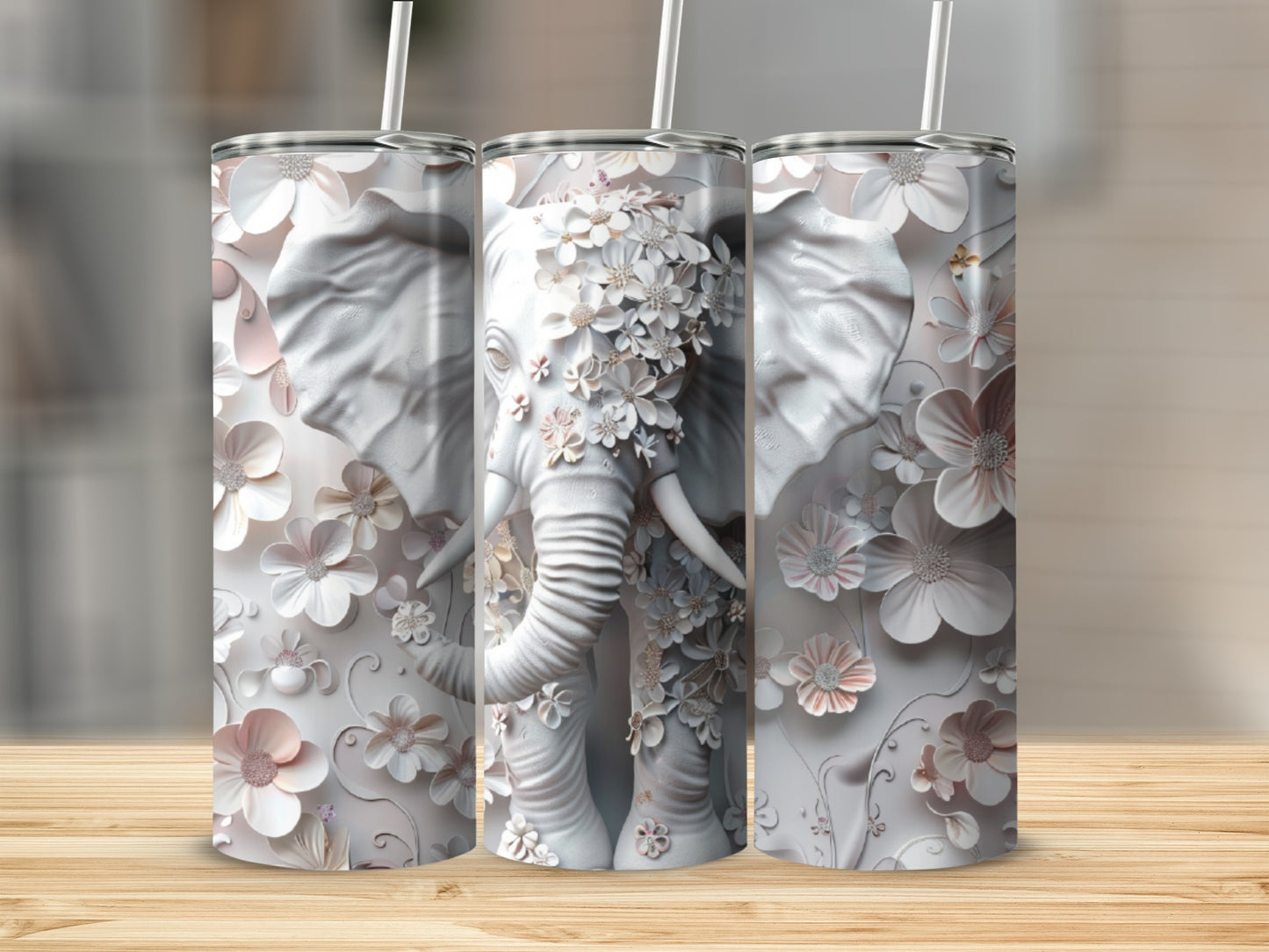 White elephant tumbler with embossed floral details and straw.