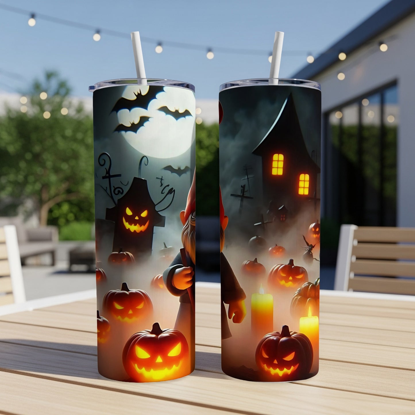Halloween tumbler with jack-o'-lanterns, bats, haunted house, and gnome on a table.