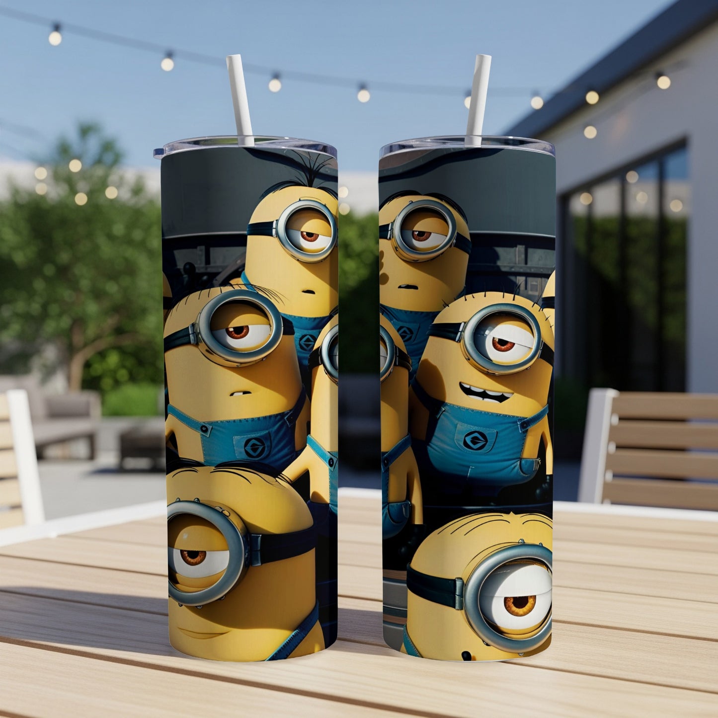 Two Minions tumblers with straws, detailed with goggles and denim overalls.