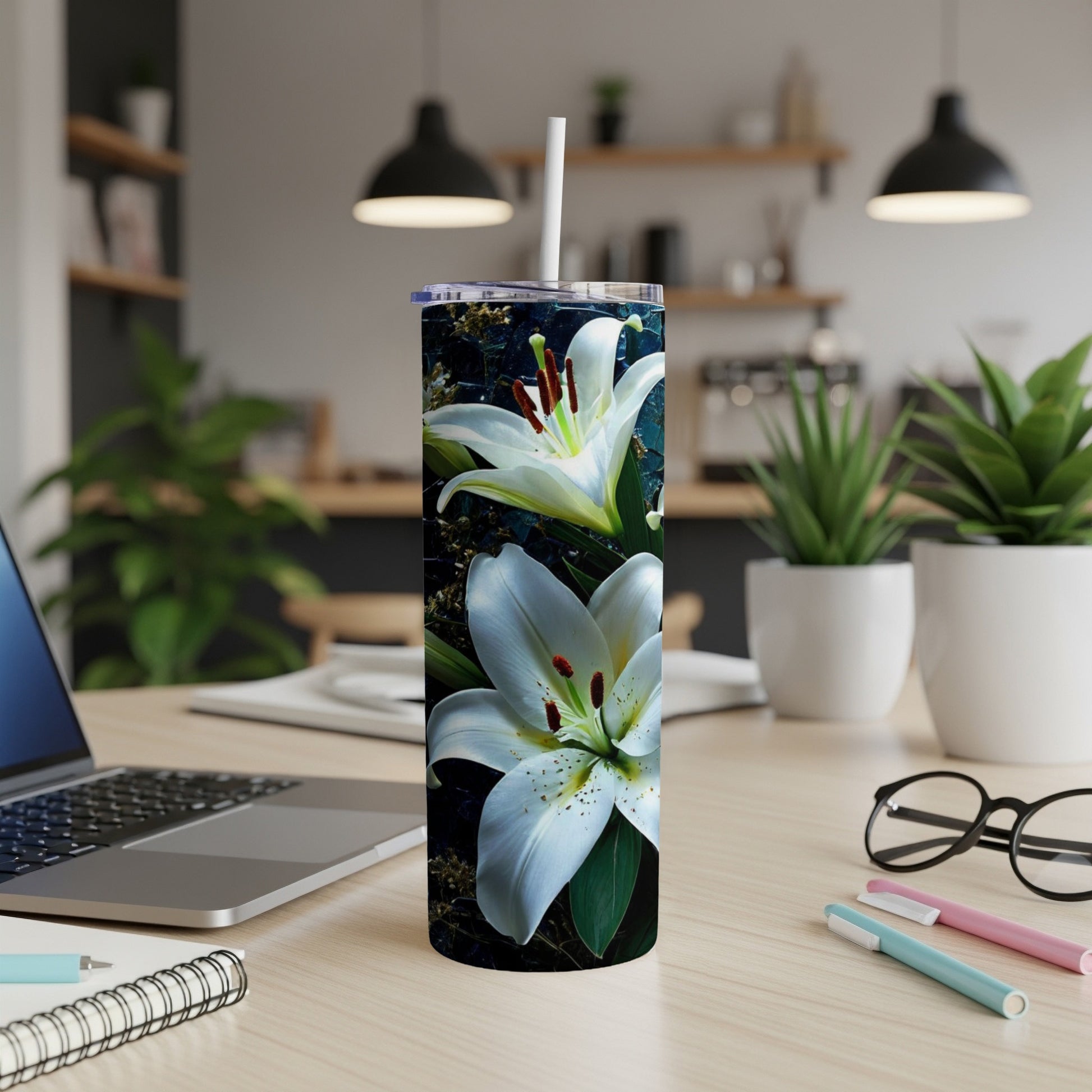 White lilies on a dark, textured background wrap a tall tumbler.