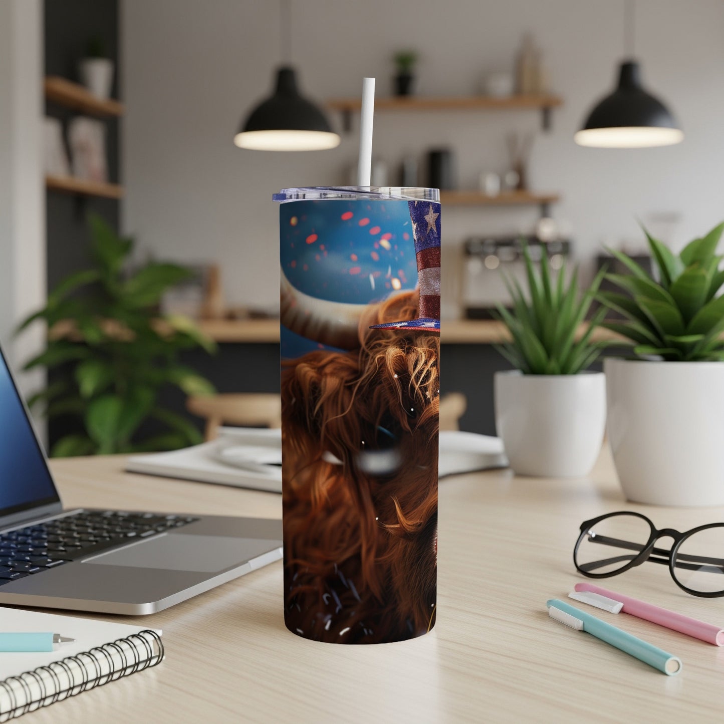 Highland cow in patriotic hat with confetti, on a tumbler.