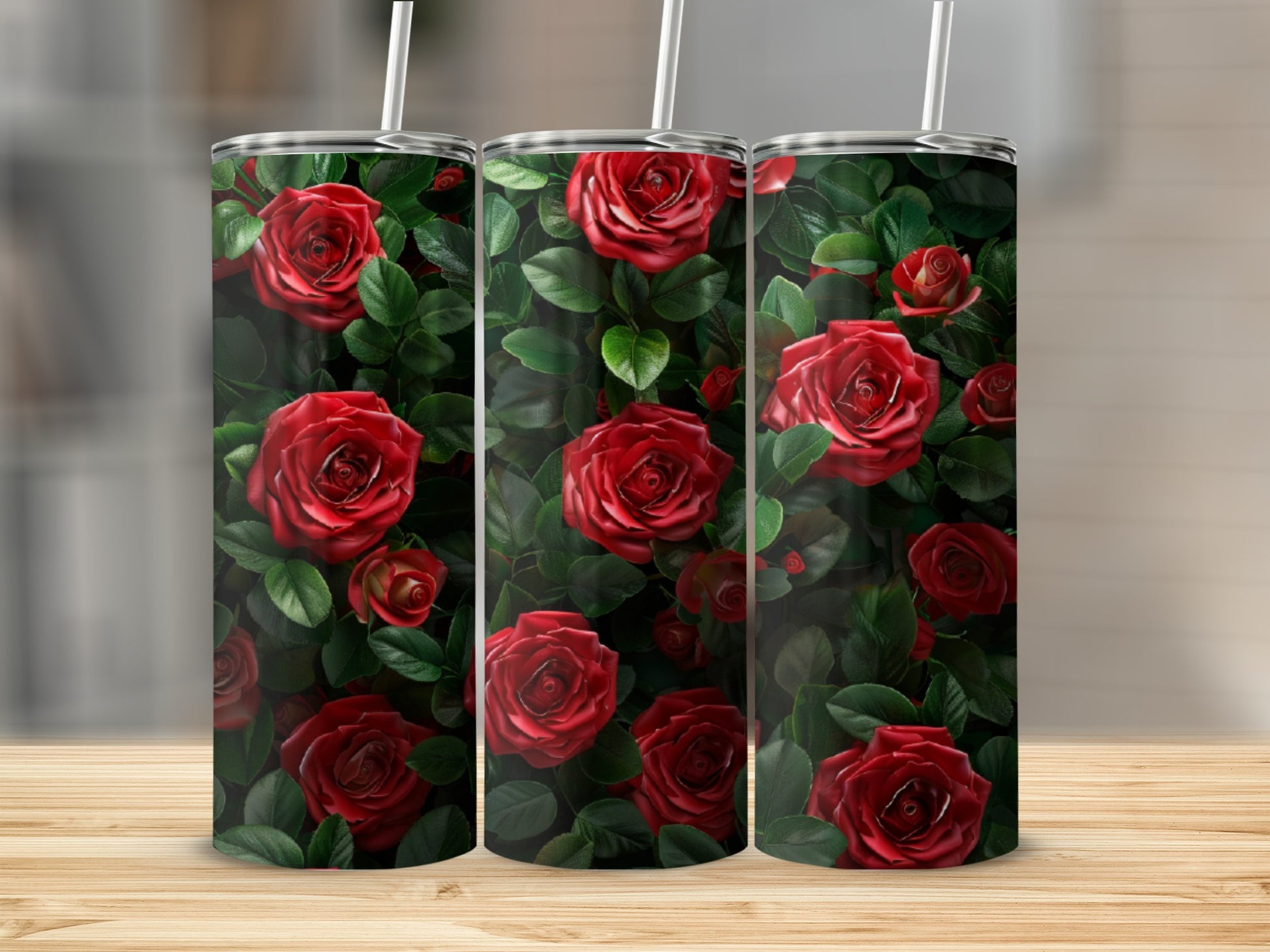 Red roses and green leaves pattern on three insulated tumblers.