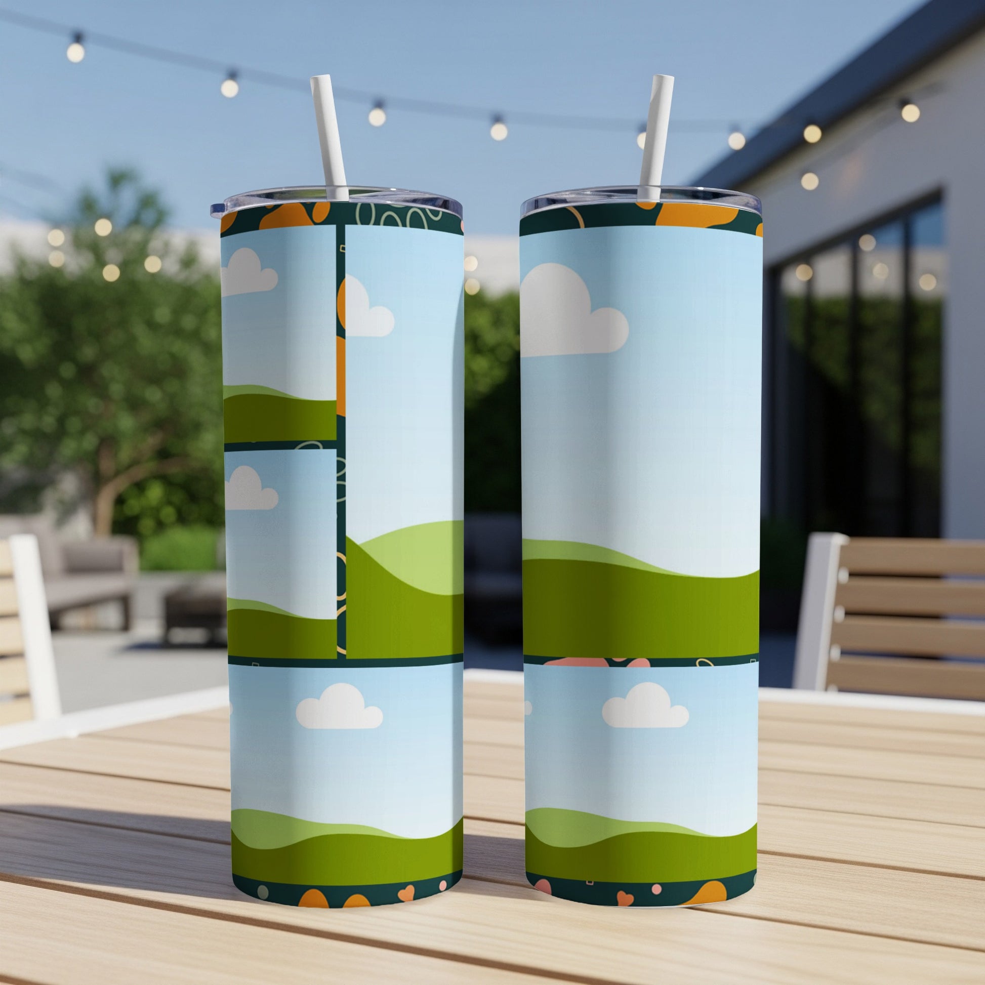 Two tall tumblers with a cartoon landscape and heart pattern on a wooden table.