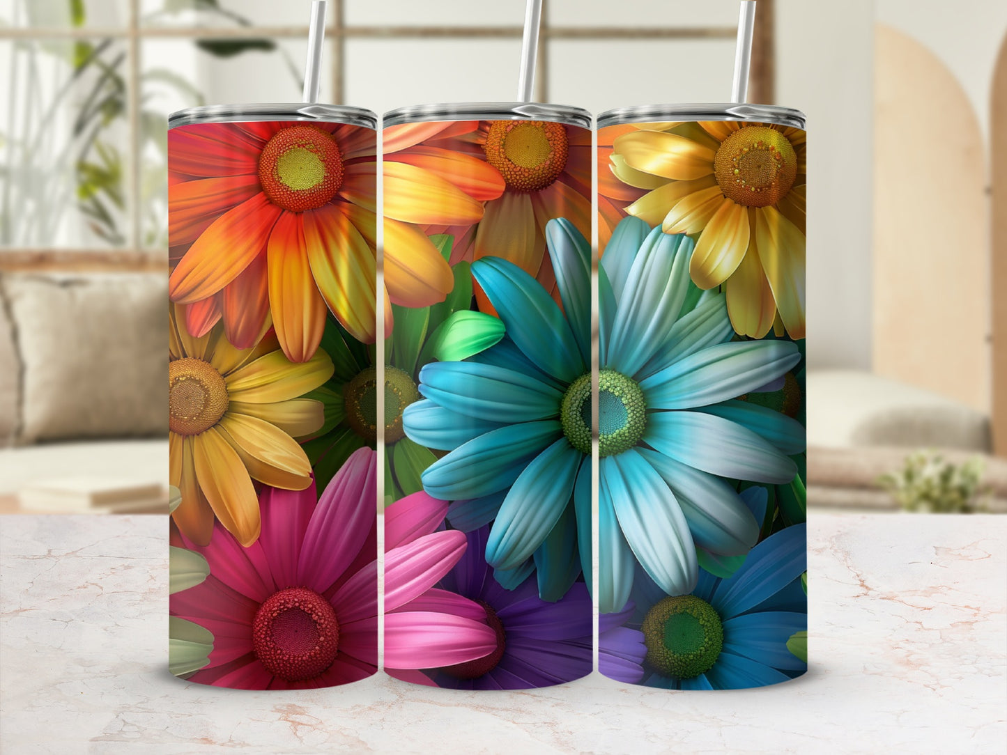 Three tumblers with colorful floral patterns on a marbled surface.