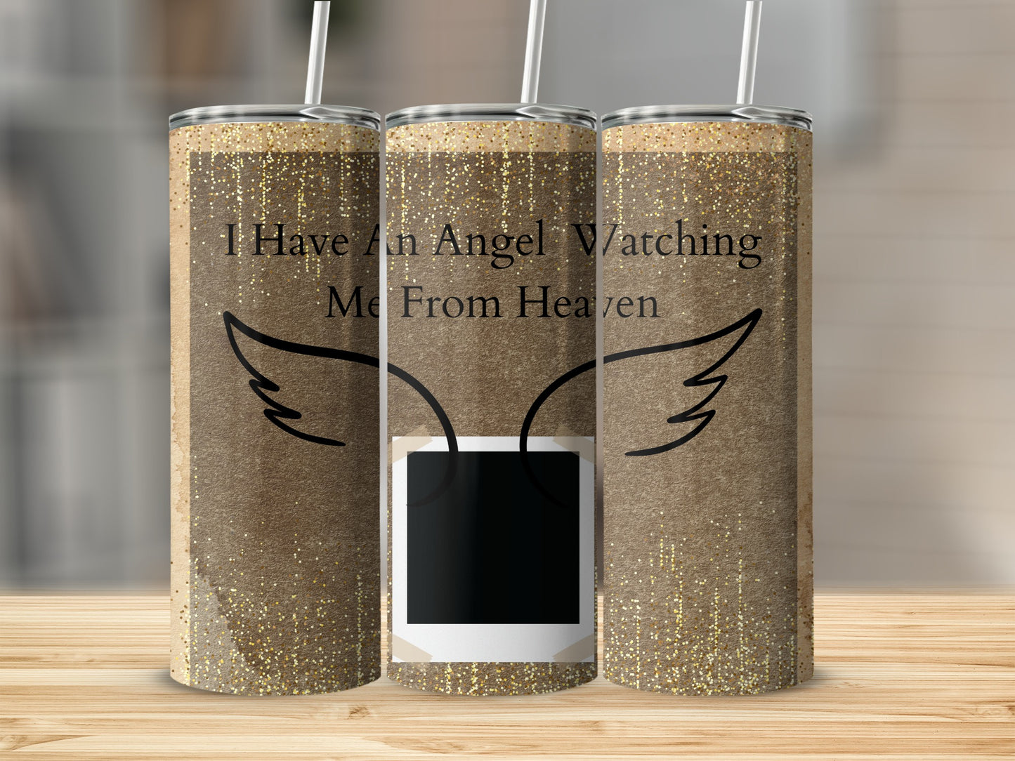Three tumblers with gold glitter, angel wings, and "I Have An Angel Watching Me From Heaven" text.