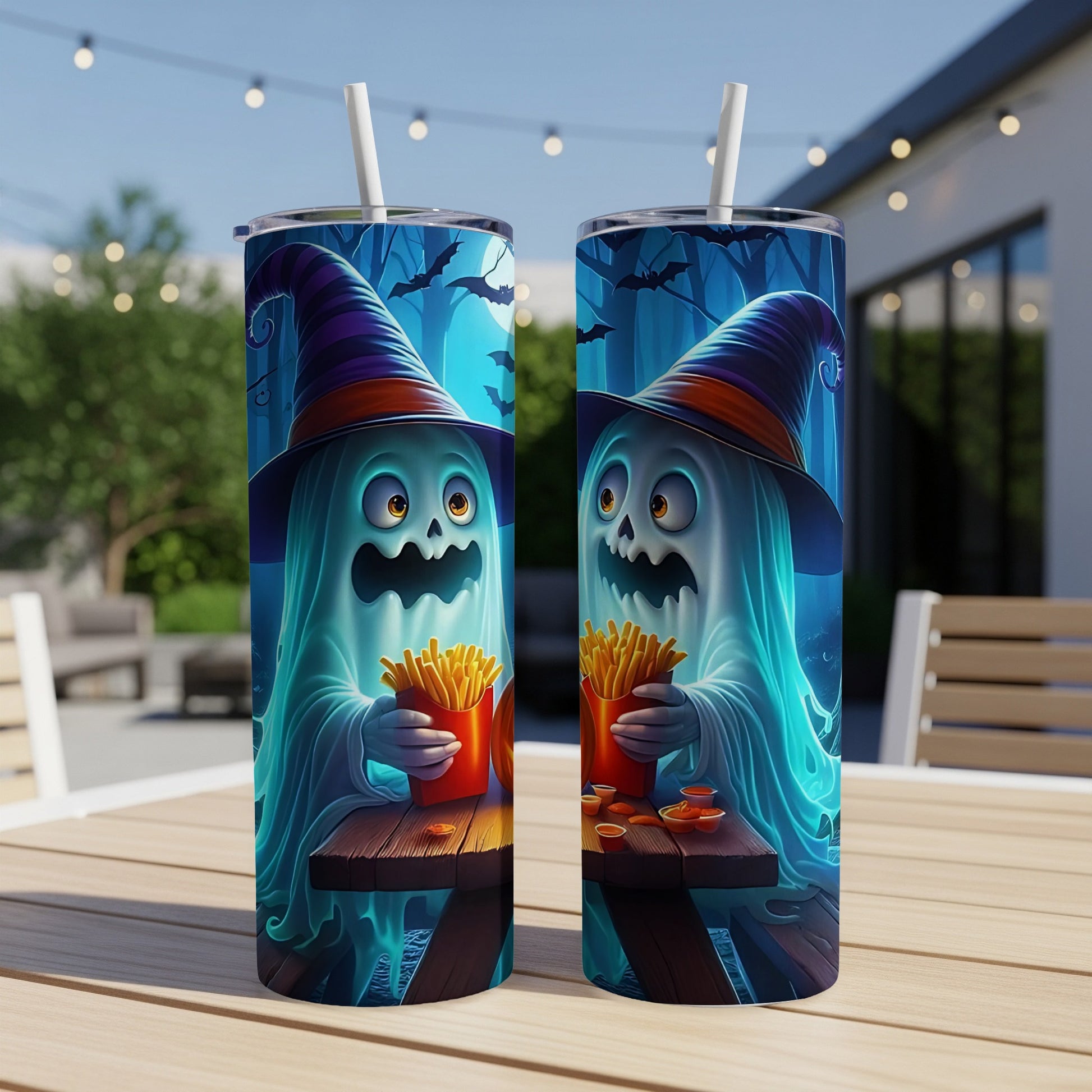 Two tumblers with cartoon ghosts in witch hats eating french fries, set on a table.