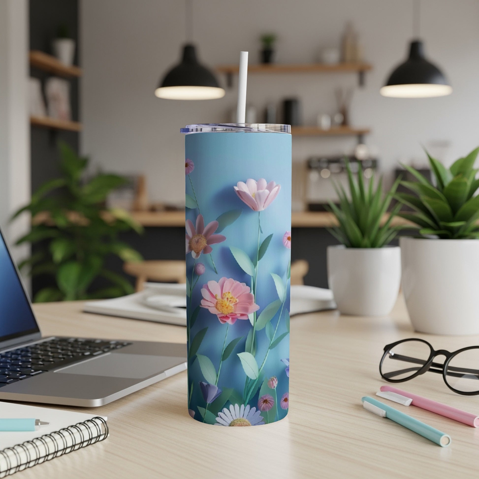 Light blue tumbler with delicate pink and purple flowers and green stems.
