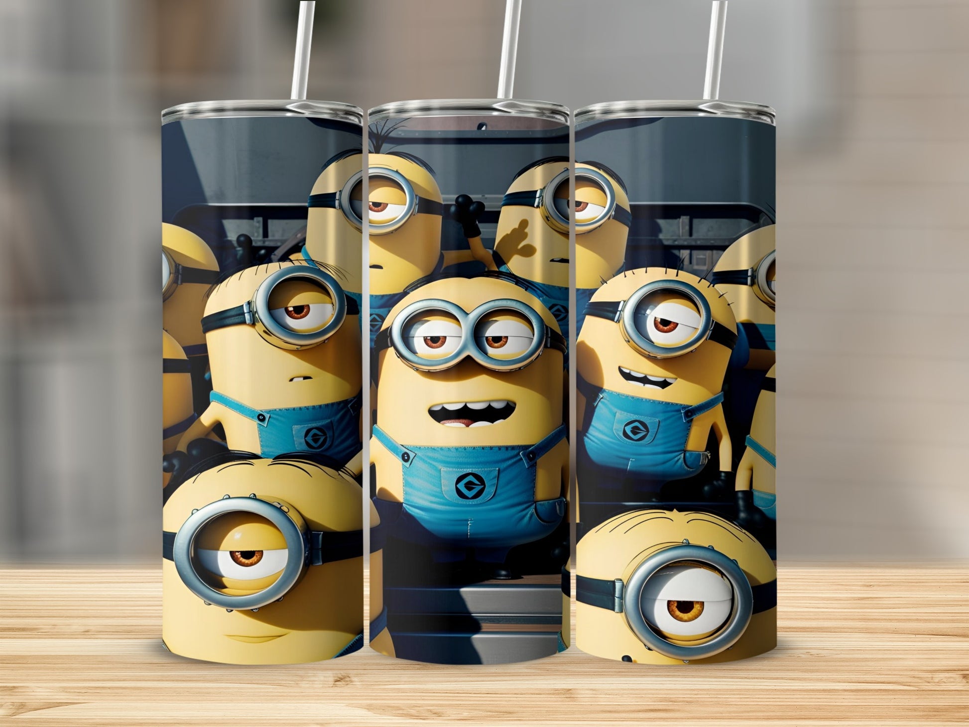 Three Minions characters with blue overalls on a tall cylindrical tumbler.