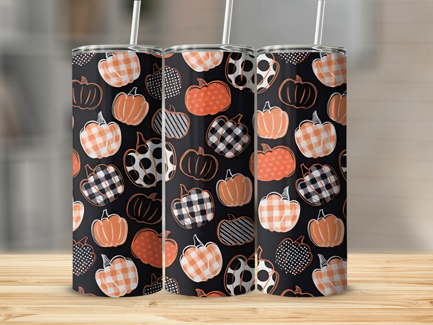Three tumblers with orange, white, and black plaid pumpkin patterns.
