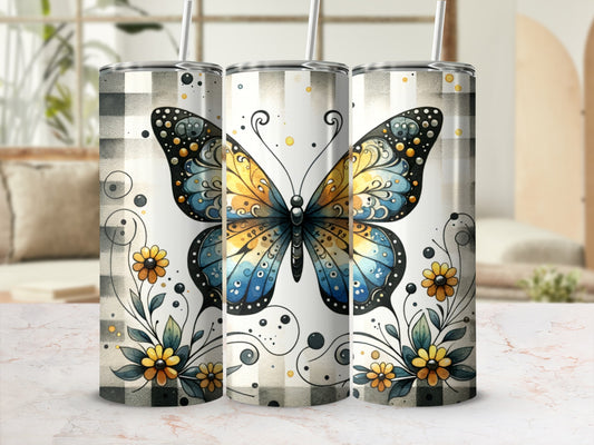 Three tumblers with colorful butterflies and floral designs on a plaid background.