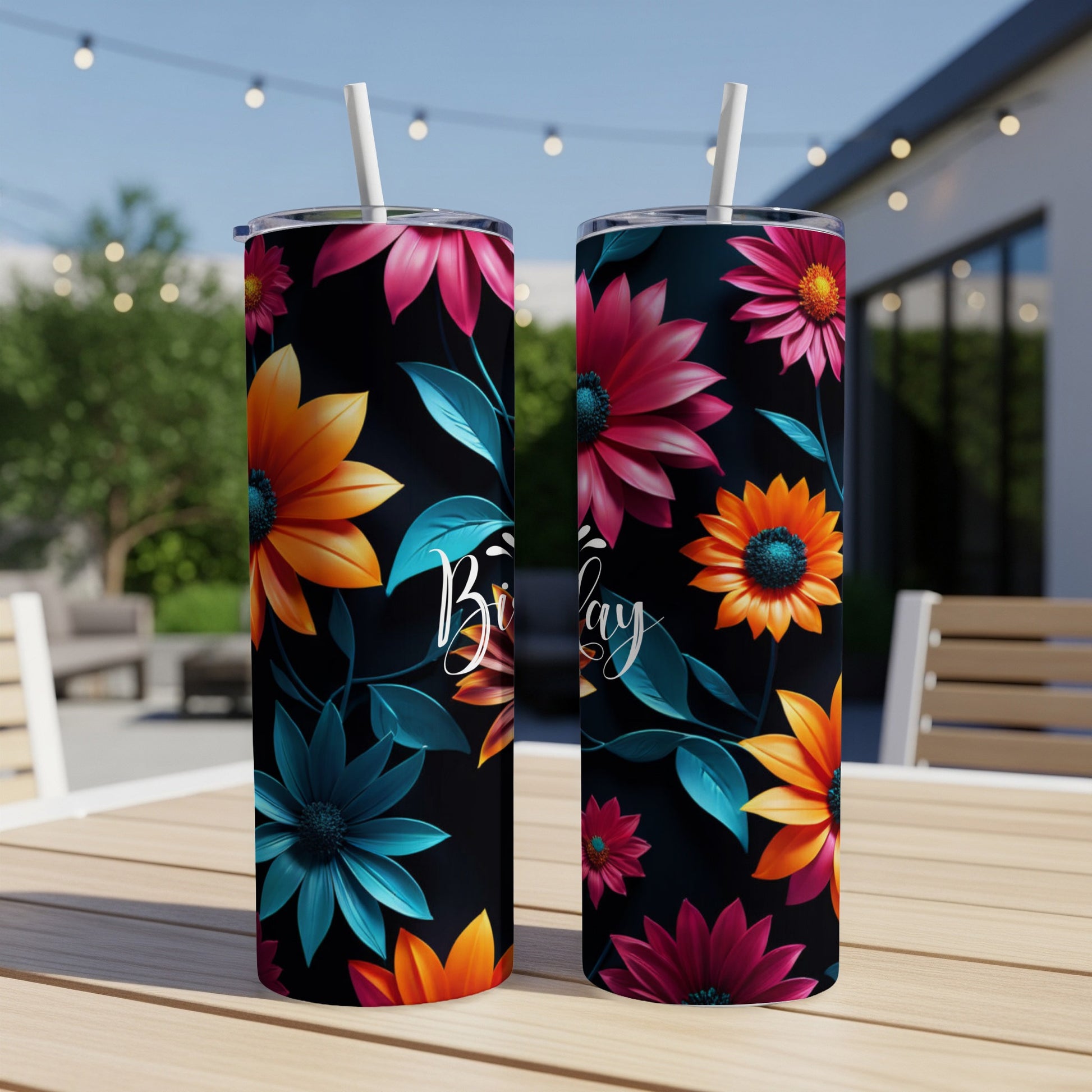 Two tumblers with floral designs and "Birthday" text on a table.