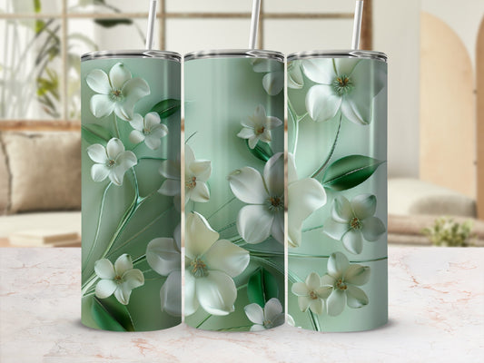 Three tumblers with white floral designs on a light green background.