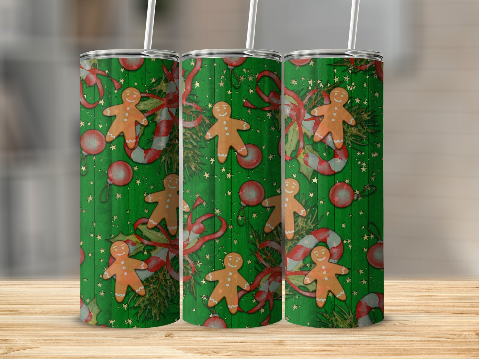 Three green tumblers with gingerbread men, candy canes, and ornaments.