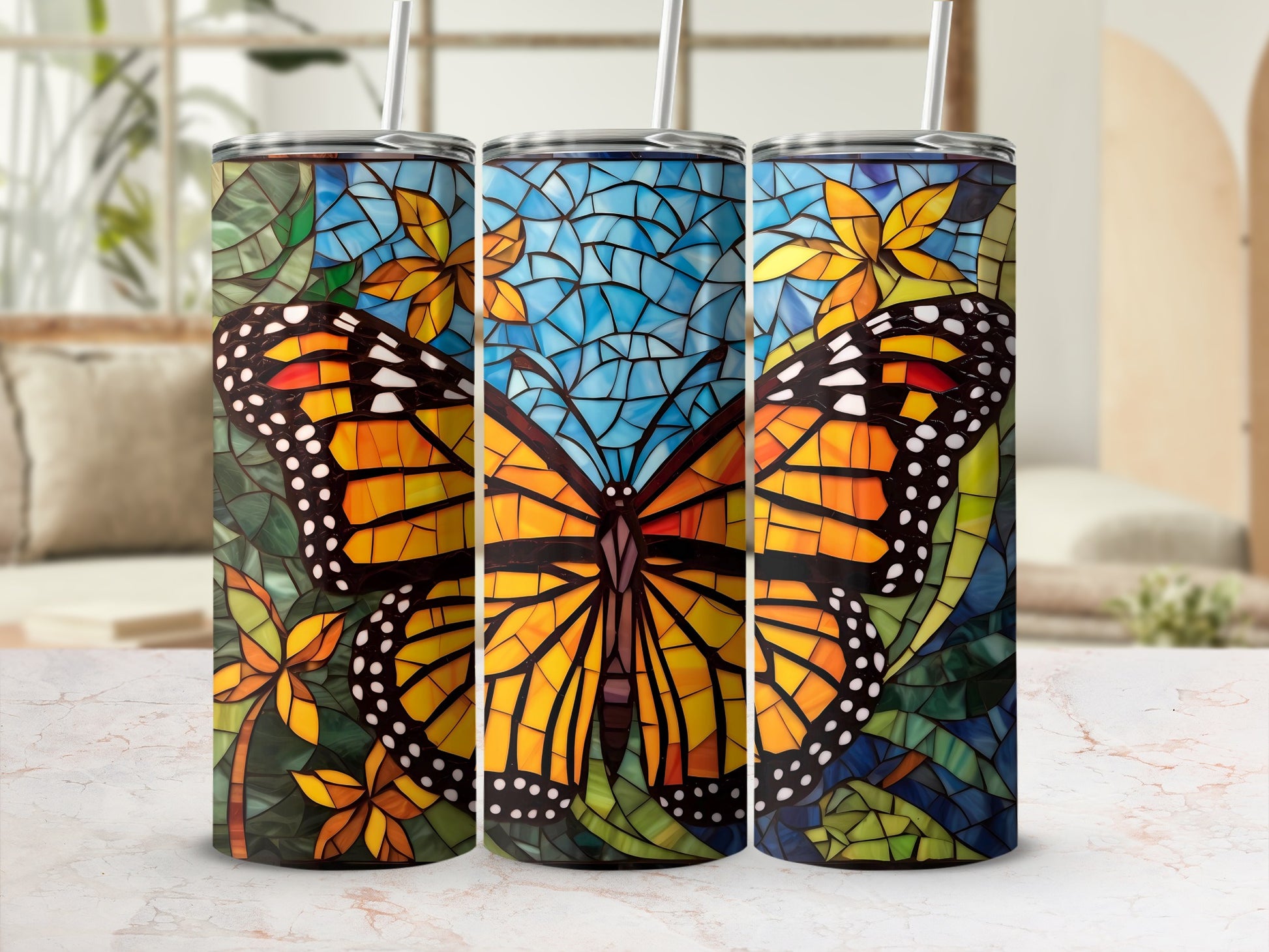 Three tumblers featuring a stained-glass butterfly and floral mosaic design.